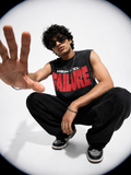 Person wearing a black sleeveless shirt with 'FAILURE' in red letters, sitting on a white background.