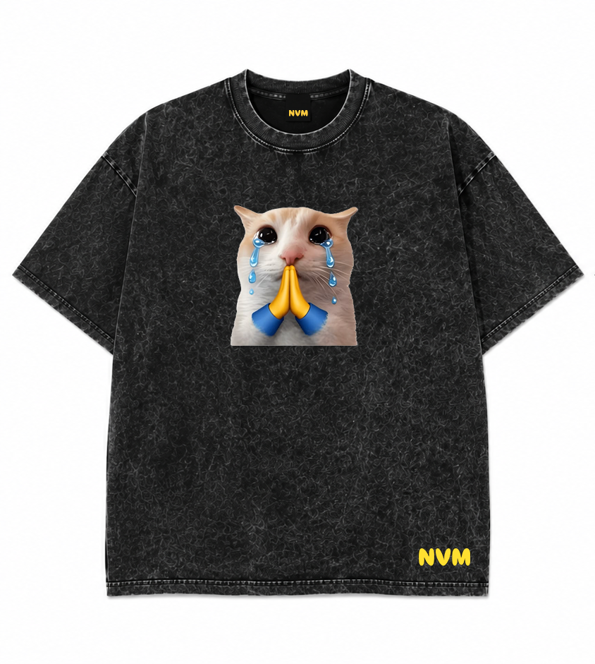 Front and back views of a black acid-wash t-shirt. The front features a graphic print of a cat's face with blue teardrops and a yellow bow, and the yellow 'NVM' logo near the bottom hem.